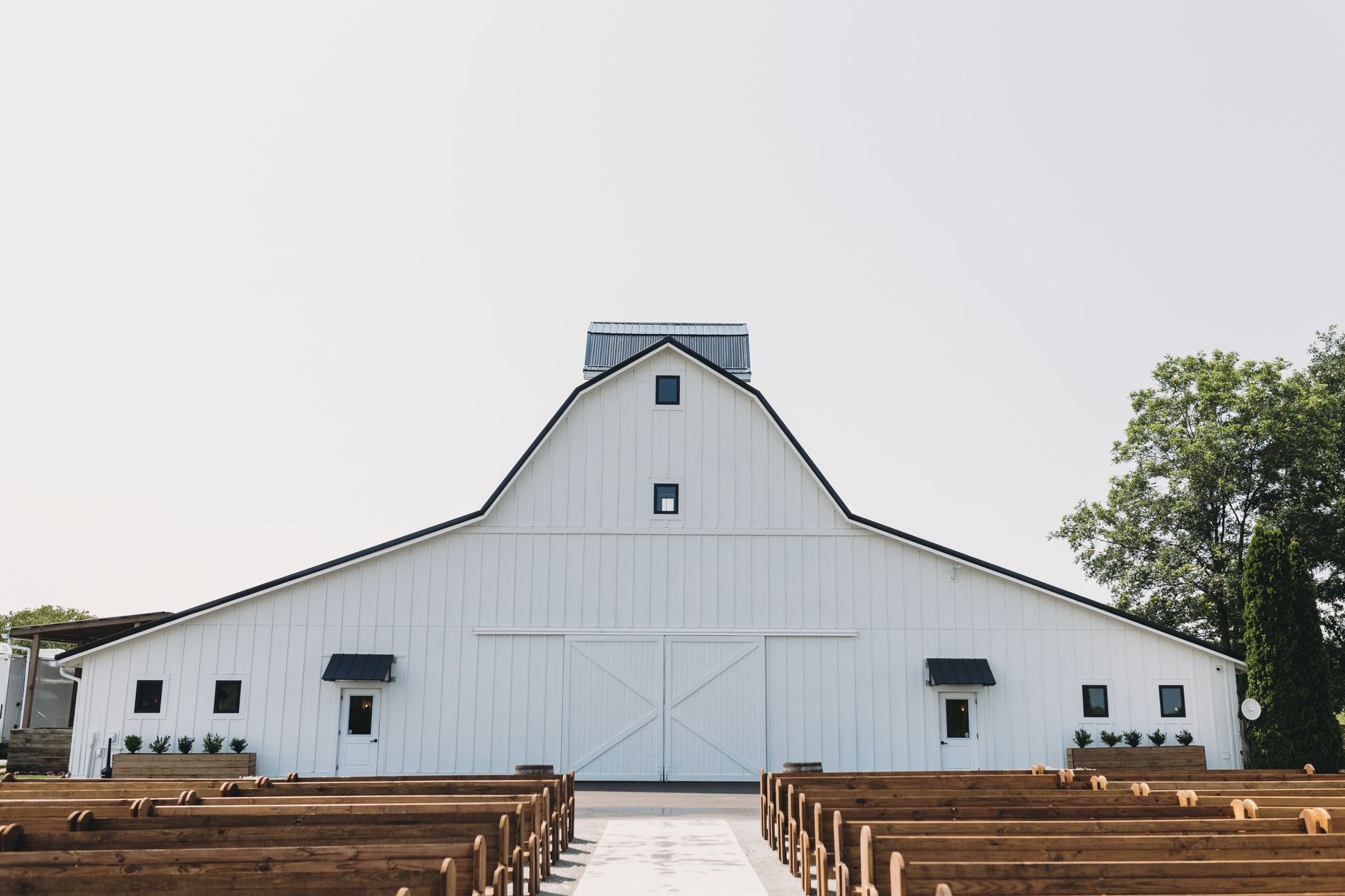 White barn wedding venue rustic benches